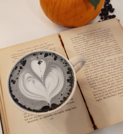 Charcoal latte on an open book