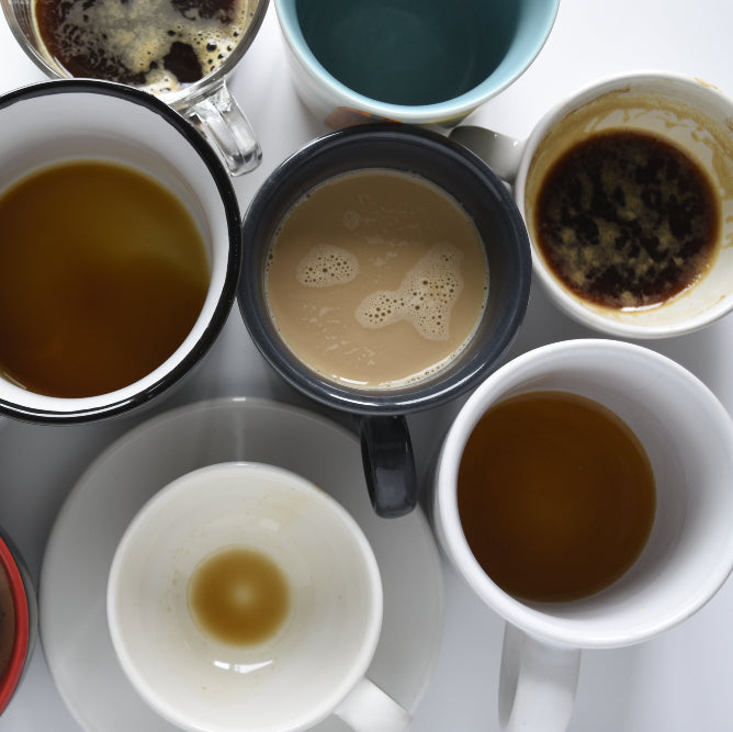 multiple mugs of coffee - full, half-full, and empty
