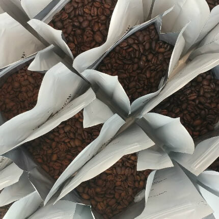 top view of open coffee bags with beans inside