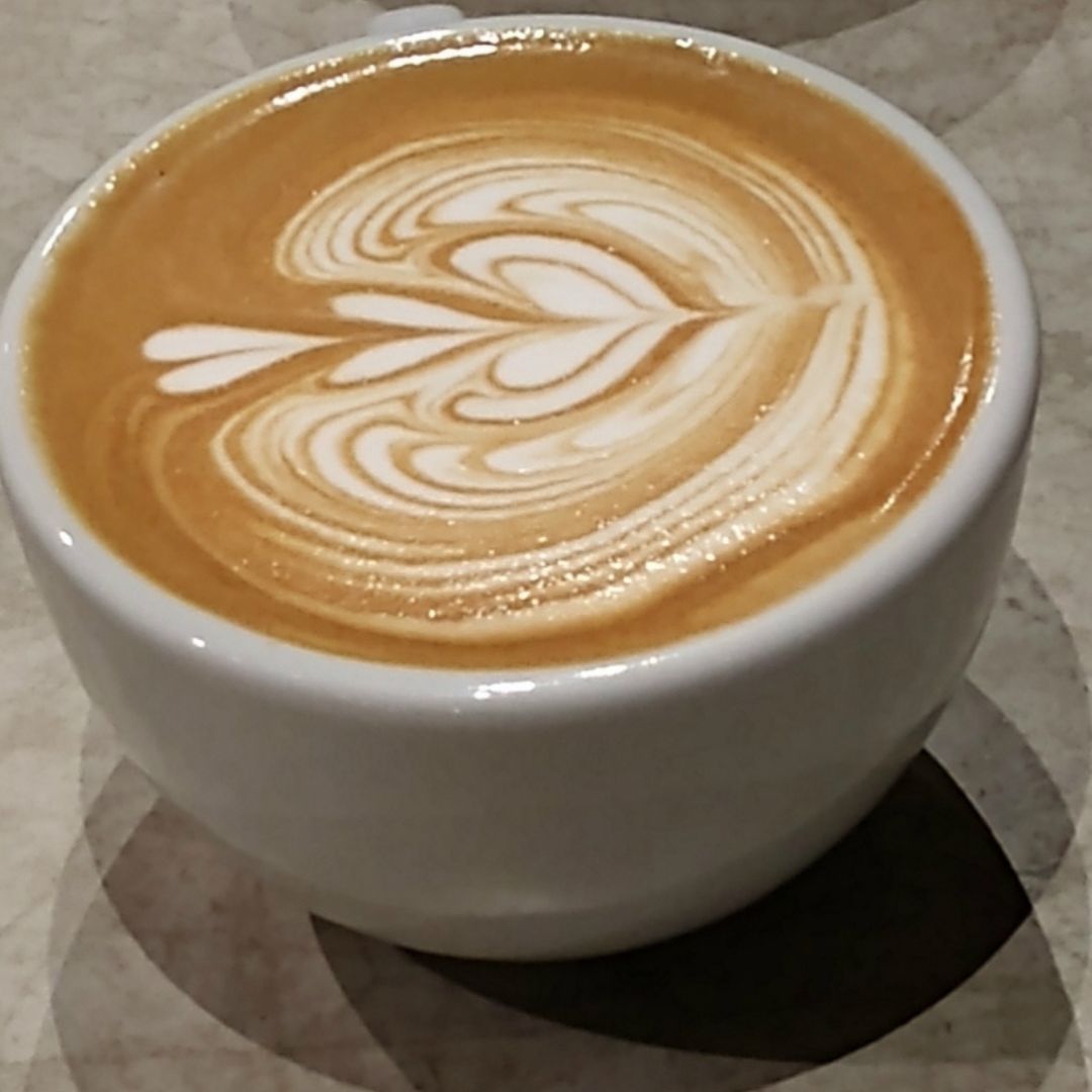 white mug with coffee and latte art