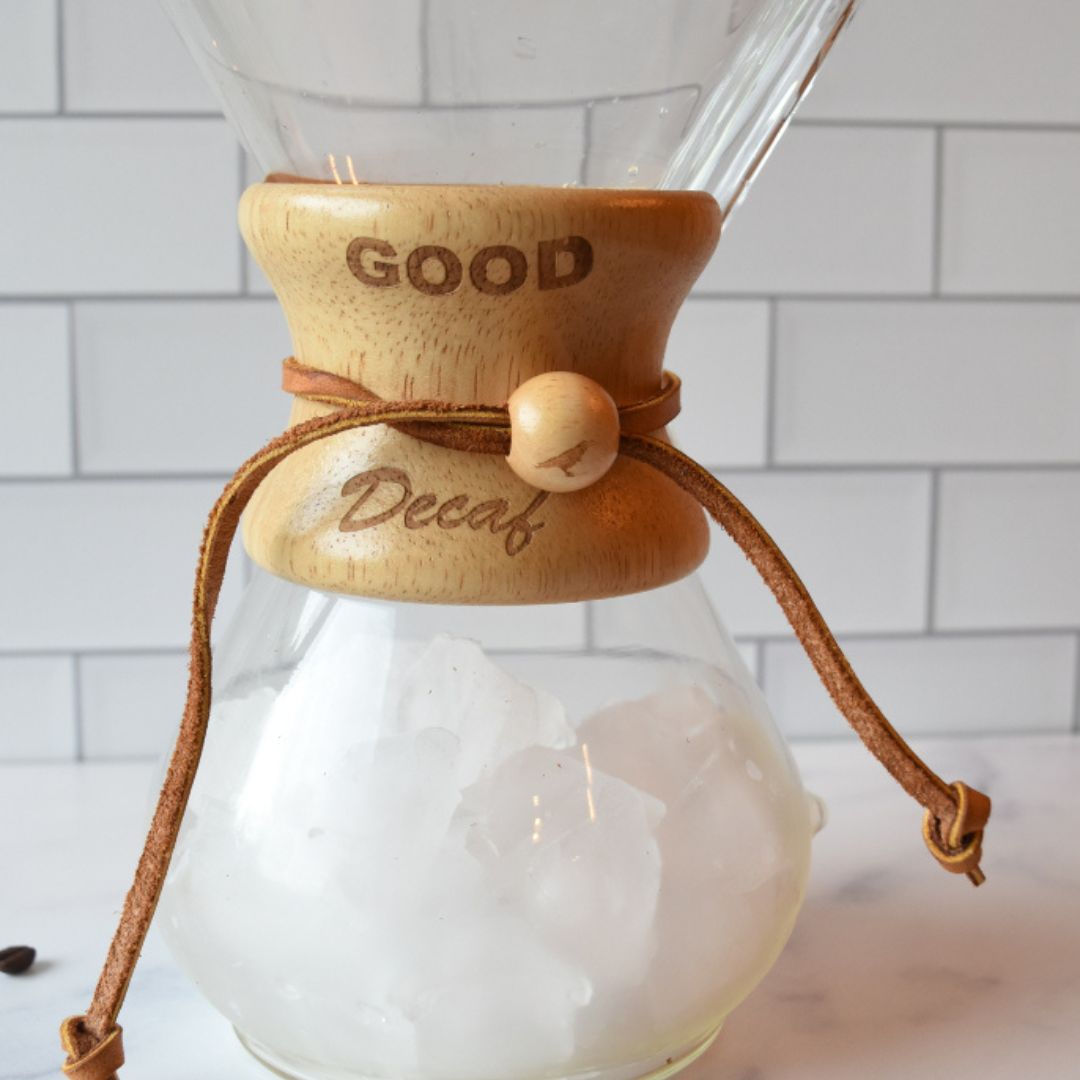 Chemex brewer filled with ice on a marble counter