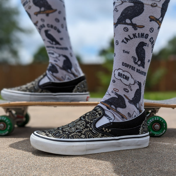 Talking crow on a skateboard saying "Decaf" and "Cawfee" fun socks