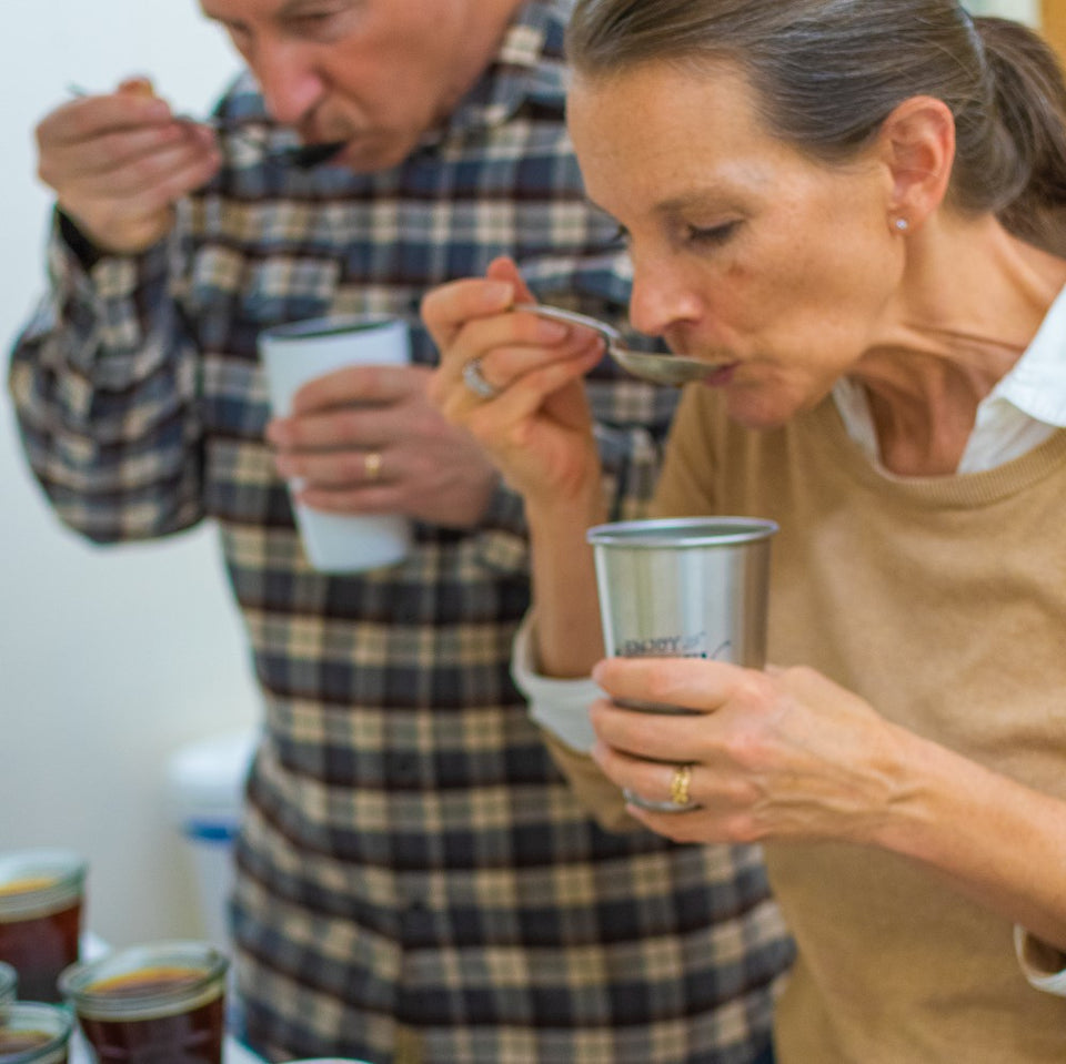 Man and woman cupping specialty coffee