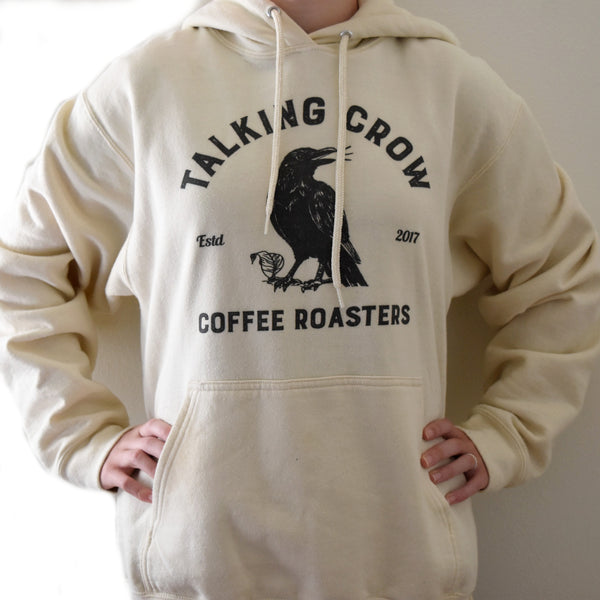 Natural color hoodie with Talking Crow Coffee Roasters logo on the front.